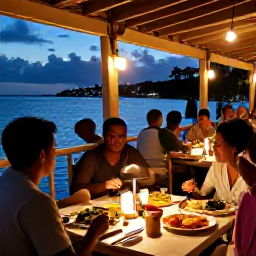 Caribbean Holidays, Grenada Adventure Holidays, A relaxed evening at a waterfront restaurant in Grenada, with freshly prepared Caribbean food, warm lights and diners enjoying the sea view