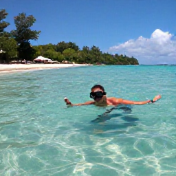 Caribbean Holidays, Grenada Backpacking, Backpacker snorkelling above clear Caribbean water at Grand Anse Beach in Grenada with a relaxed shoreline behind