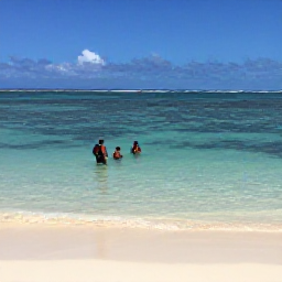 Caribbean Holidays, Grenada Backpacking, Backpackers snorkelling above a clear coral reef at Grand Anse Beach, Grenada, with white sand and calm blue water