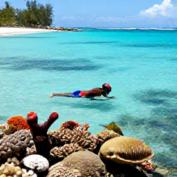 Caribbean Holidays, Grenada Beach Holidays, Snorkeller exploring clear water above colourful coral and tropical fish near a quiet Grenada beach, viewed in bright May sunshine