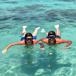 Caribbean Holidays, Grenada Couples Holiday, A couple swimming and snorkelling above clear water near Grand Anse Beach in Grenada, with colourful fish and coral visible