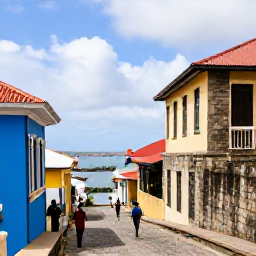 Caribbean Holidays, Grenada February, Visitors exploring the historic streets of St George's, Grenada, with colourful houses, stone buildings and views towards the harbour