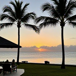 Caribbean Holidays, Grenada Holidays May, A relaxed Caribbean sunset over Grenada, with a calm sea, silhouettes of palm trees and a welcoming resort terrace