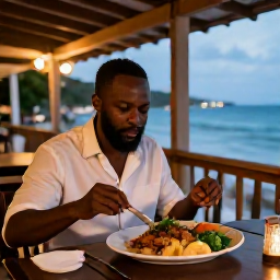 Caribbean Holidays, Grenada Holidays, Traveller enjoying a fresh Grenadian meal at a relaxed waterfront restaurant in St George's during a warm April evening