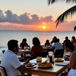 Caribbean Holidays, Grenada in April, A relaxed evening at a Grenada beachfront restaurant, with diners enjoying local food as the sun sets over the Caribbean Sea
