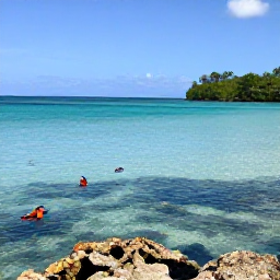 Caribbean Holidays, Grenada in February, A quiet tropical cove in Grenada with clear turquoise water, snorkellers and colourful fish near a reef