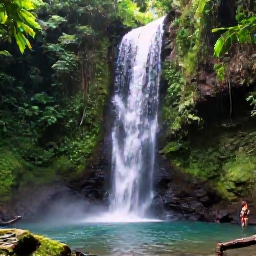 Caribbean Holidays, Grenada Instagram Spots, Waterfall in Grenada's lush rainforest with a clear pool, tropical greenery and a visitor standing near the cascade