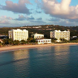 Caribbean Holidays, Grenada Luxury Holidays, Aerial view of Grand Anse Beach in Grenada with calm turquoise water, soft white sand and elegant beachfront hotels in warm May sunshine