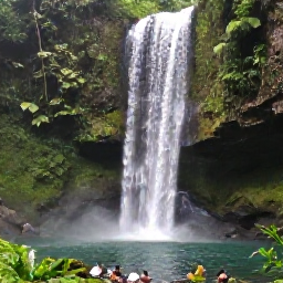Caribbean Holidays, Grenada Multi-Country, Waterfall and lush rainforest in Grenada, tropical plants, mossy rocks and a natural pool with a small group of visitors
