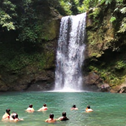Caribbean Holidays, Grenada Nature Holidays, A scenic waterfall in Grenada surrounded by tropical forest, with visitors swimming in a clear natural pool during June
