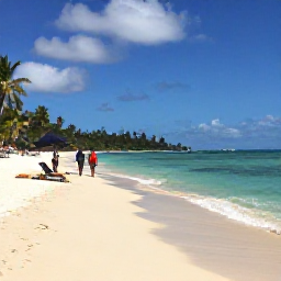 Caribbean Holidays, Grenada September Holidays, Grand Anse Beach in Grenada with soft white sand, clear water, sun loungers and a couple strolling along the shoreline