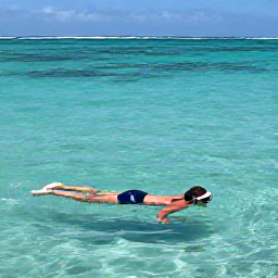 Caribbean Holidays, Grenada Solo Holidays, Solo visitor swimming and snorkelling over clear water near Grand Anse Beach in Grenada, with colourful fish and a calm April sea