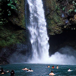 Caribbean Holidays, Guadeloupe Adventure, A dramatic Guadeloupe waterfall surrounded by tropical forest, with visitors swimming in a clear natural pool