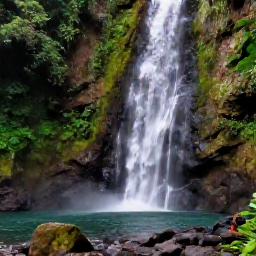 Caribbean Holidays, Guadeloupe Adventure Holidays, Visitors canyoning beside a waterfall and rocky stream in the tropical mountains of Guadeloupe