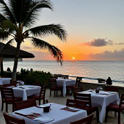 Caribbean Holidays, Guadeloupe Beaches, A relaxed Guadeloupe beachside restaurant at sunset, with outdoor tables, Creole food and a view across the Caribbean sea
