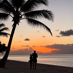 Caribbean Holidays, Guadeloupe Birdwatching, Friendly couple enjoying a quiet evening on a Guadeloupe beach after a day of birdwatching, with palms and a warm Caribbean sunset