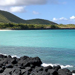 Caribbean Holidays, Guadeloupe in February, Quiet Guadeloupe coastline in February with turquoise water, black volcanic rocks and green hills in the background
