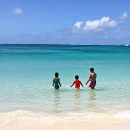 Caribbean Holidays, Guadeloupe in June, Family swimming and playing in the clear shallow water of Sainte-Anne beach, Guadeloupe