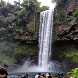 Caribbean Holidays, Guadeloupe in May, Carbet Falls surrounded by tropical rainforest in Guadeloupe, with water cascading over rocks and hikers viewing the scene
