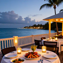 Caribbean Holidays, Guadeloupe Luxury Holidays, Elegant Guadeloupe restaurant terrace at dusk, serving fresh seafood and Caribbean cuisine beside the sea with warm lantern light