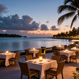 Caribbean Holidays, Guadeloupe October Break, Relaxed Guadeloupe evening waterfront with outdoor tables, warm lights and a calm Caribbean harbour at sunset