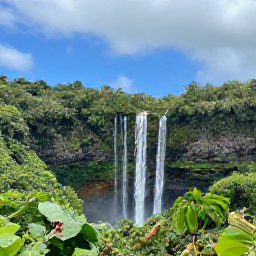 Caribbean Holidays, Guadeloupe October Break, Scenic Guadeloupe road trip through lush tropical hills, with a waterfall viewpoint and blue sky after a brief rain shower