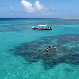 Caribbean Holidays, Guadeloupe September Holidays, A small boat and snorkellers exploring clear water near a coral reef off the Guadeloupe coast