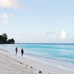 Caribbean Holidays, Guadeloupe Solo Holidays, Bright February morning at Grande-Terre beach in Guadeloupe, white sand, calm turquoise water and a solo visitor walking beside the shore