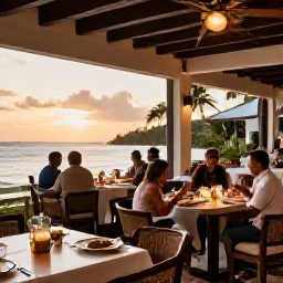 Caribbean Holidays, Guadeloupe Spa Breaks, An elegant seaside restaurant in Guadeloupe at sunset, with relaxed diners, local Caribbean dishes and soft warm light