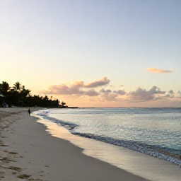 Caribbean Holidays, Guadeloupe Spa Breaks, Quiet Guadeloupe beach at sunrise in January, with soft sand, calm Caribbean water and a person walking along the shore