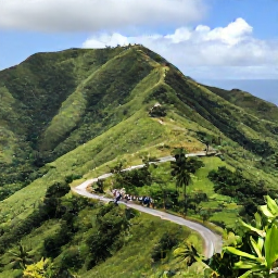 Caribbean Holidays, Haiti Luxury Holidays, A scenic Haitian mountain viewpoint in May, with green hills, tropical vegetation, a winding road and travellers enjoying a guided cultural excursion