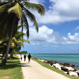 Caribbean Holidays, Haiti Walking Holidays, A quiet Haitian coastal path with walkers, palm trees, turquoise sea and soft October sunshine after a tropical shower