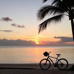 Caribbean Holidays, Jamaica Cycling June, Jamaican beach at sunset with a touring bicycle resting near the shore, calm sea and palm silhouettes
