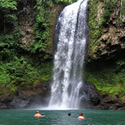 Caribbean Holidays, Jamaica in February, Travellers swimming beneath a Jamaican waterfall surrounded by green tropical forest and rocks
