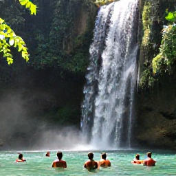 Caribbean Holidays, Jamaica in June, Jamaican waterfall surrounded by tropical vegetation, with travellers swimming in a clear pool beneath cascading water
