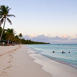 Caribbean Holidays, Jamaica in May, A peaceful Jamaican beach at sunrise in May, with turquoise water, pale sand, palm trees and a few snorkellers offshore