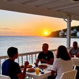Caribbean Holidays, January Beach Holidays, An outdoor waterfront restaurant in Charlotte Amalie, St Thomas, at sunset with diners enjoying Caribbean food and harbour views