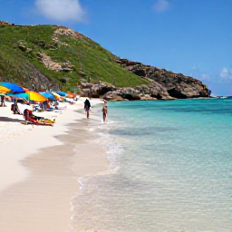 Caribbean Holidays, January Beach Holidays, Visitors relaxing on Cas Abao Beach in Cura&ccedil;ao, with clear shallow sea, colourful umbrellas and rocky green hills in the background