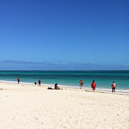 Caribbean Holidays, January Beach Holidays, Wide white-sand beach on Providenciales in January, calm turquoise sea, bright Caribbean sunshine and a few relaxed holidaymakers