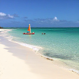 Caribbean Holidays, January Escapes, White sand beach and crystal-clear shallow sea in the Tobago Cays, with snorkellers and a small sailing boat