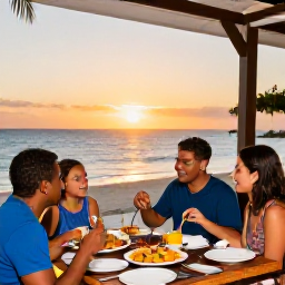 Caribbean Holidays, January Family Holidays, A family enjoying a casual sunset meal at an outdoor restaurant in Grand Cayman, colourful local food and a relaxed island atmosphere