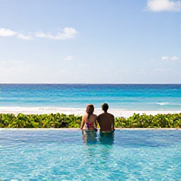 Caribbean Holidays, January Honeymoons, Couple enjoying a peaceful luxury hotel pool overlooking the Caribbean Sea in January