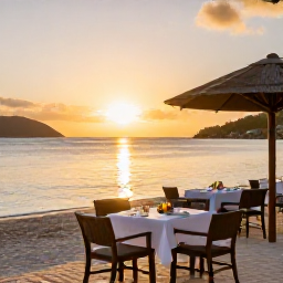 Caribbean Holidays, January Luxury Holidays, Golden sunset over a luxury beachfront restaurant in the British Virgin Islands, tables set for dinner beside calm Caribbean water