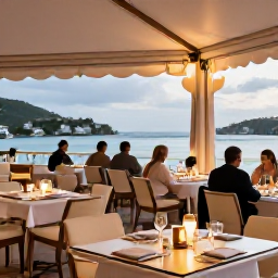 Caribbean Holidays, January Luxury Holidays, Upscale restaurant terrace in Gustavia, Saint Barth&eacute;lemy, with elegant tables, harbour views and diners enjoying an evening meal