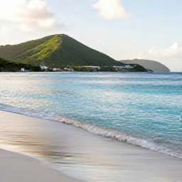 Caribbean Holidays, January Nature Holidays, Quiet Caribbean beach on Saint Martin in January, clear turquoise water, soft morning light and green hills in the background