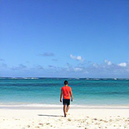 Caribbean Holidays, January Solo Holidays, A solo traveller walking along a bright white sandy beach in Curacao during January, calm turquoise sea and clear blue sky