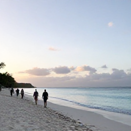 Caribbean Holidays, January Walking Holidays, Walkers strolling along a wide white-sand beach at sunrise on Grace Bay, Providenciales, with calm turquoise sea