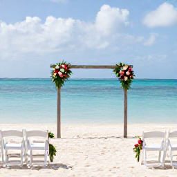 Caribbean Holidays, January Weddings, Elegant small beach wedding ceremony in Providenciales, Turks and Caicos, with white chairs, tropical flowers and calm blue water