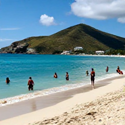 Caribbean Holidays, July Beach Holidays, Visitors swimming and relaxing at Orient Bay Beach, Saint Martin, with turquoise sea, soft sand and low green hills in the background