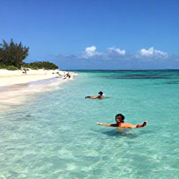 Caribbean Holidays, July Beach Holidays, Visitors swimming and snorkelling in clear shallow water beside a sandy beach in Turks and Caicos during a sunny July day